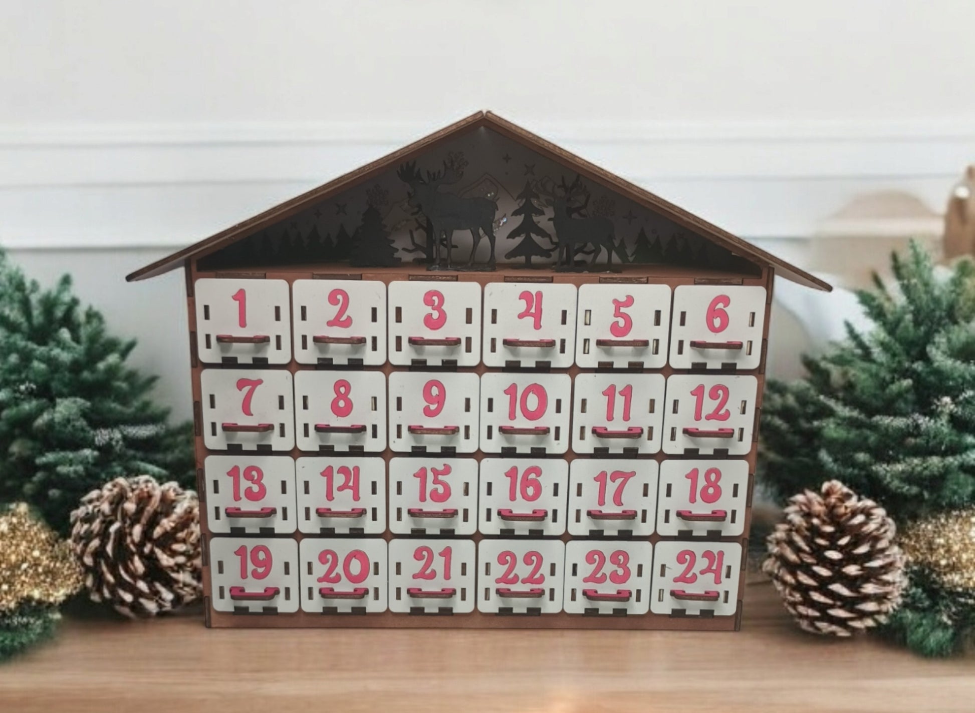Close-up of advent calendar drawer pulled open to show fillable compartment for small gifts or candy.