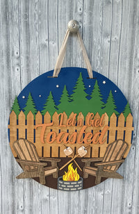 Thumbnail for Alt Text: 3D layered wood camping door sign featuring marshmallow skewers and Adirondack chairs.