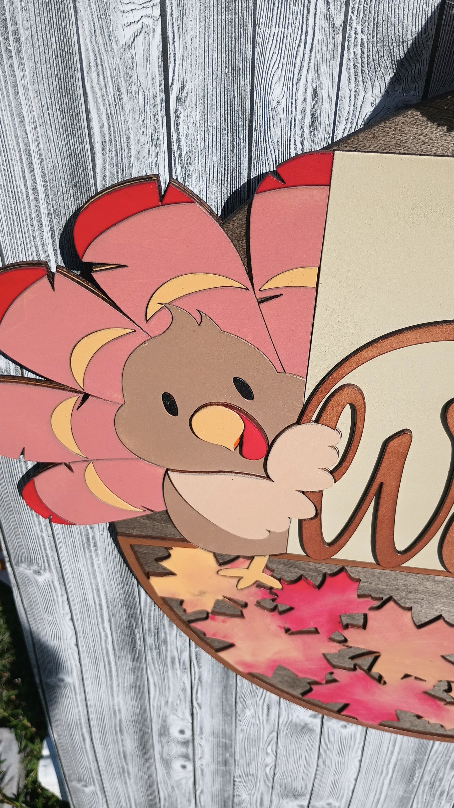 Festive wooden Thanksgiving welcome sign with hand painted details and layered bow