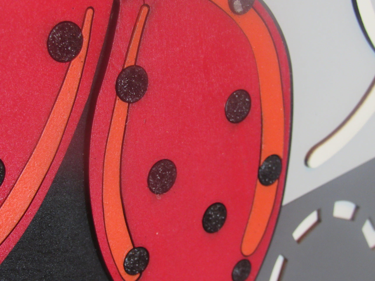 Hand-painted ladybug decor with bright red and black colors for front doors and patios.