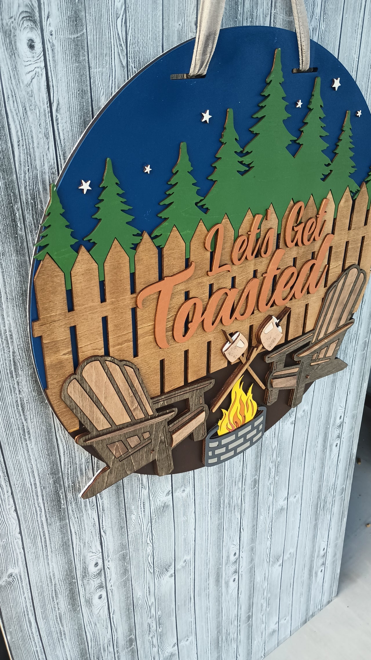 Large outdoor cabin decor with campfire and forest backdrop, perfect for RV or campsite use.