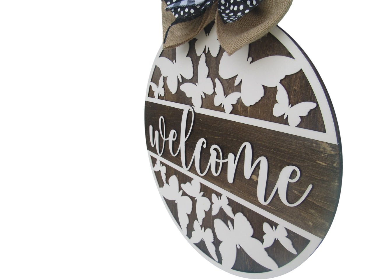 Large round door sign with butterfly cutouts and layered ribbon bow
