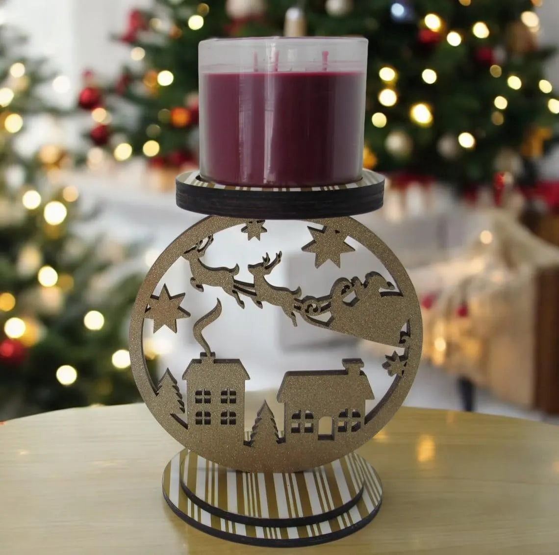 Santa sleigh 3-wick Christmas candle holder with glitter accents, featuring village and reindeer design for holiday table decor.