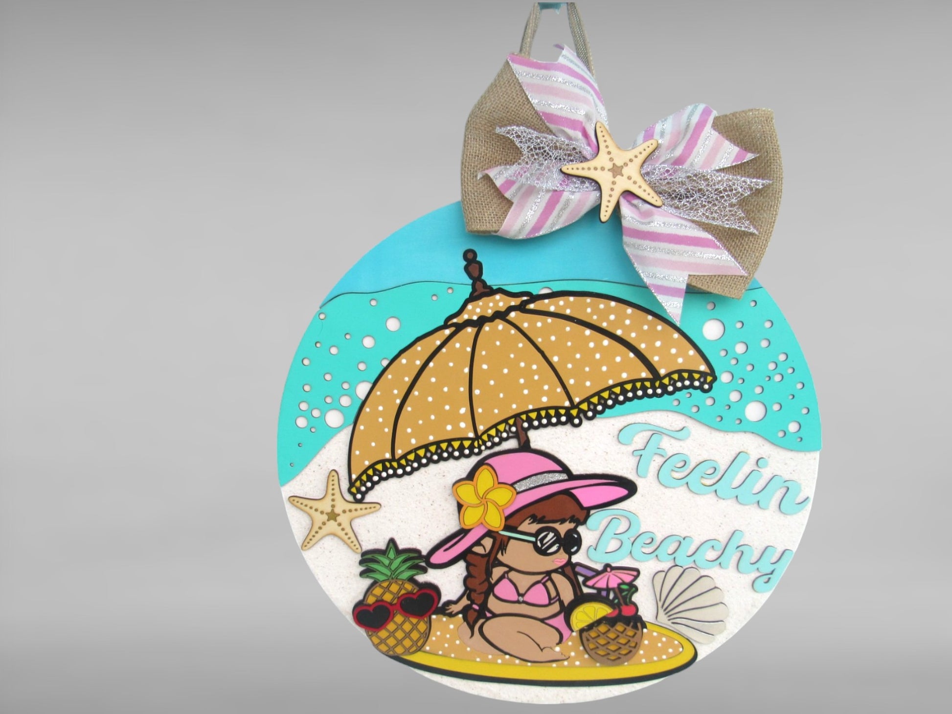 Round summer beach sign with girl in pink hat, pineapples, and coastal bow accent