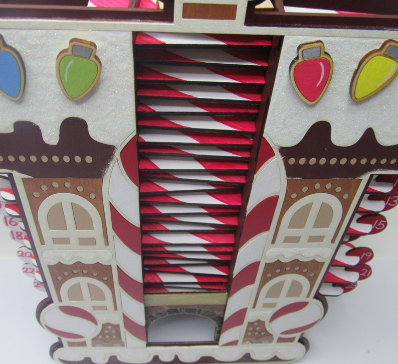 Santa-themed Christmas countdown calendar with a candy cane motif and rooftop design