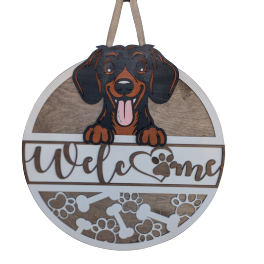 Round wooden sign with a dachshund illustration and 'Welcome' text on a white background