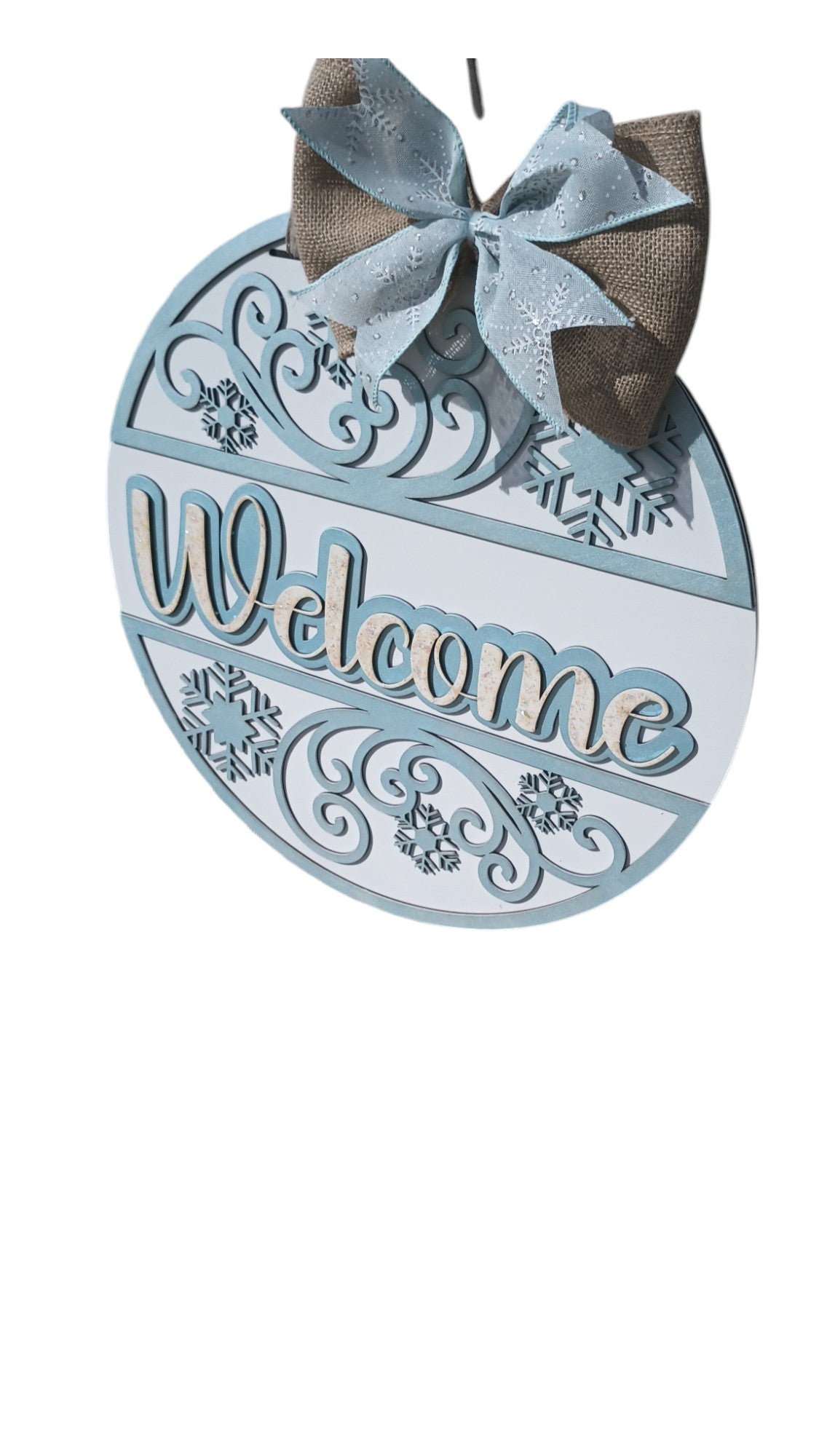 Elegant winter door hanger with snowflake cutouts, hand-painted swirls, and burlap bow for a cozy seasonal front door display