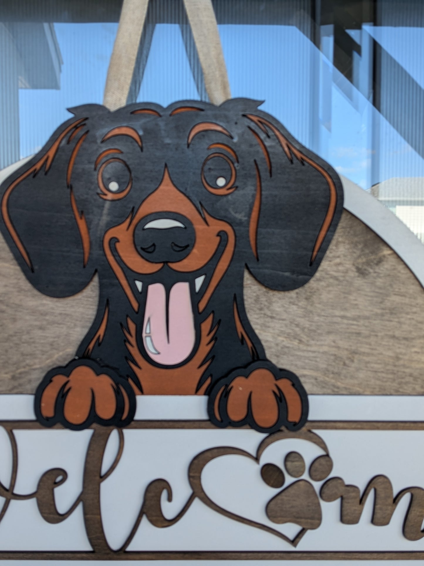 Wooden sign with a dachshund dog design and 'Welcome' text.