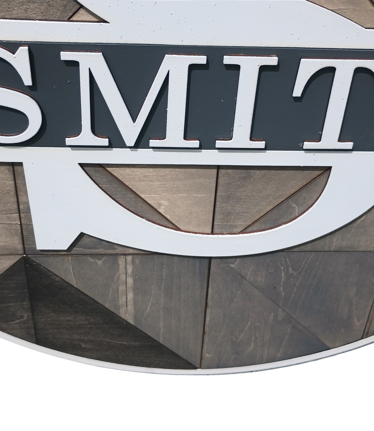 Neutral farmhouse style monogram door decor sign with geometric wood pattern

