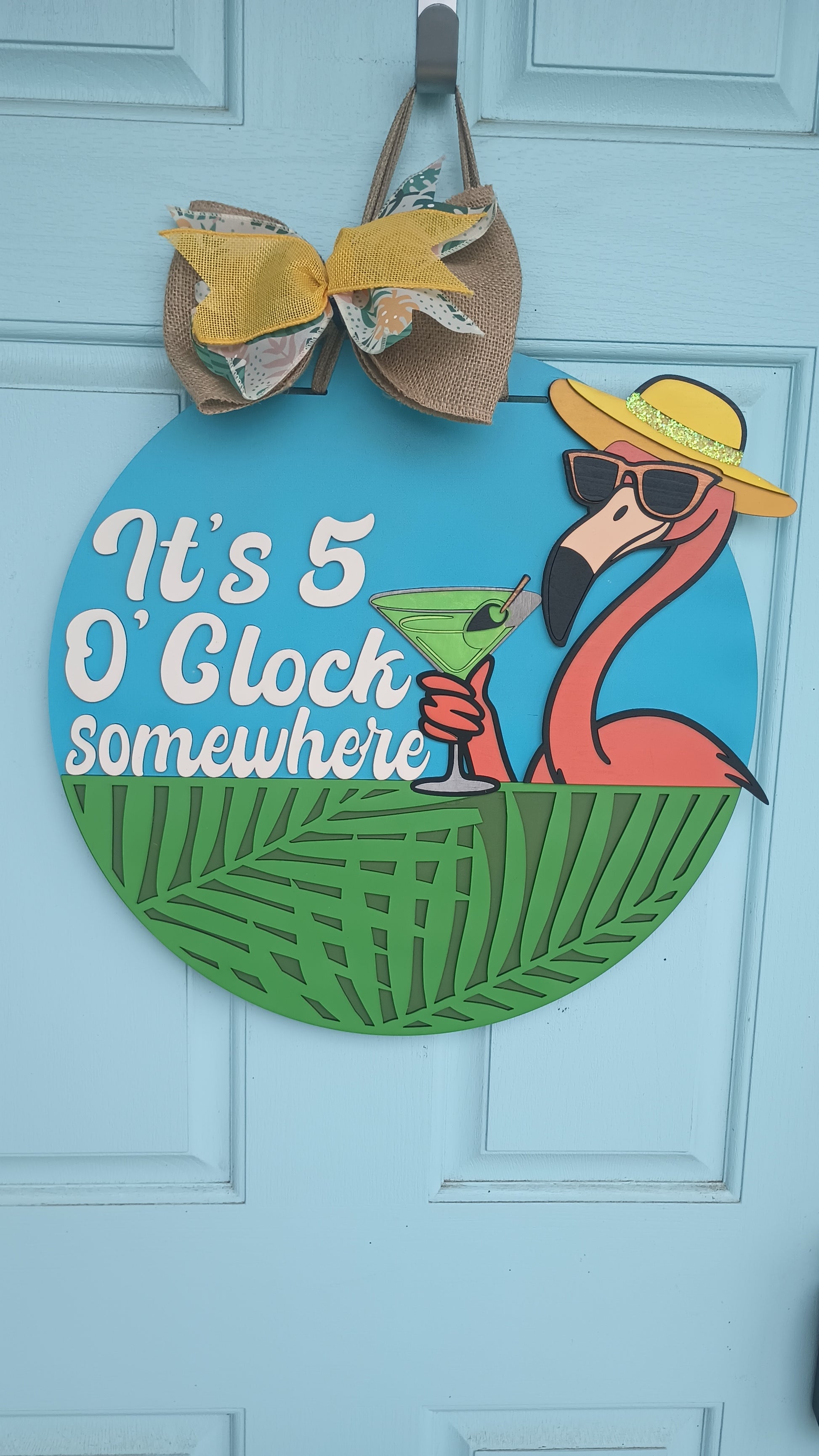 Flamingo welcome sign with burlap bow and tropical colors

