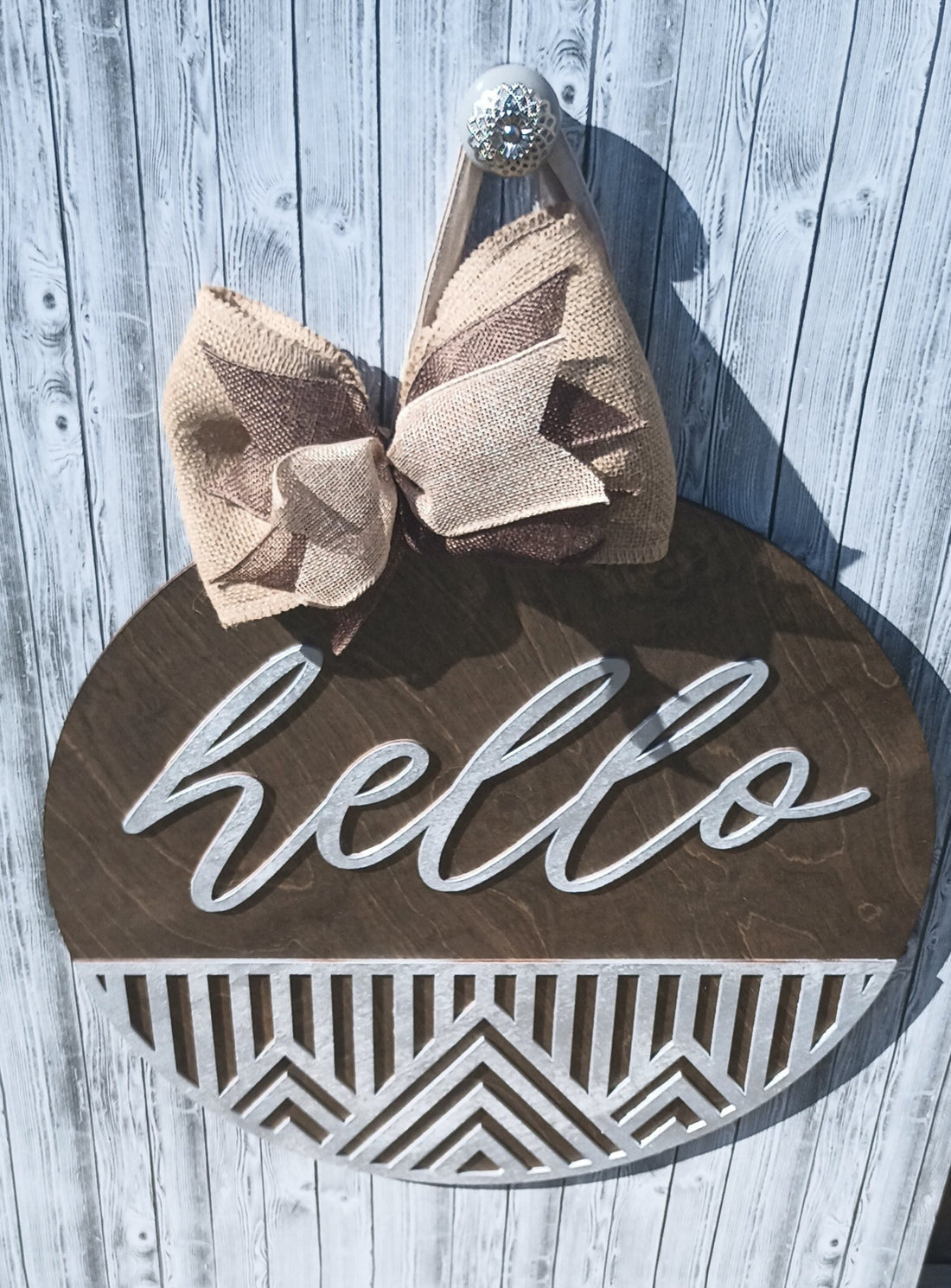  Large 18" diameter wooden door hanger with white script "Hello" and burlap bow for outdoor decor.