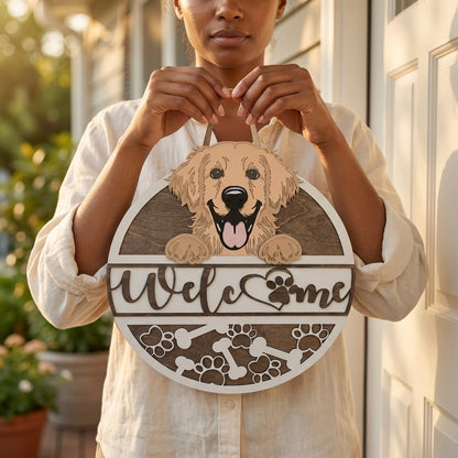 Person holding a wooden sign with a golden retriever dog illustration and Welcome text.