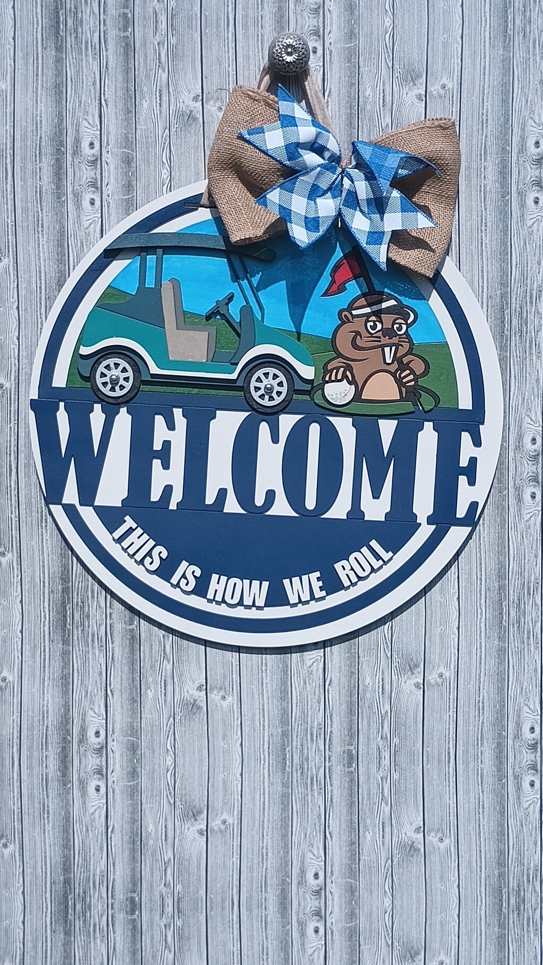 Handcrafted golf door hanger with bold welcome text and playful golf scene.