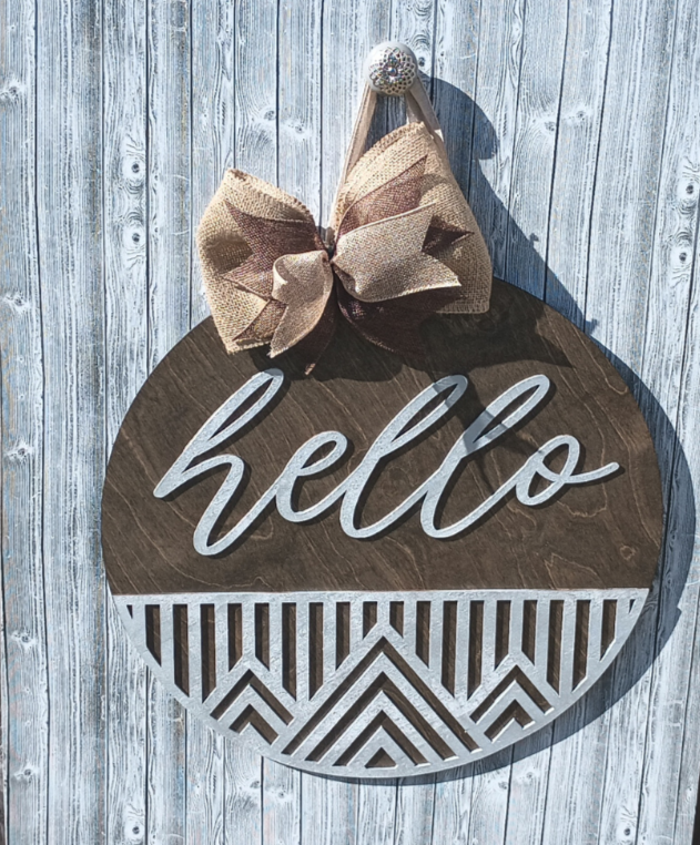 18" round wood welcome sign with laser-cut geometric accents and natural burlap bow.