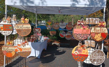 Lasernique fall craft show setup outdoors under a tent