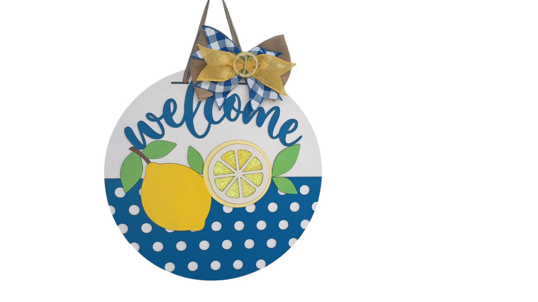 Handcrafted lemon decor door hanger with blue polka dots and welcome script, perfect for kitchen wall or front door.