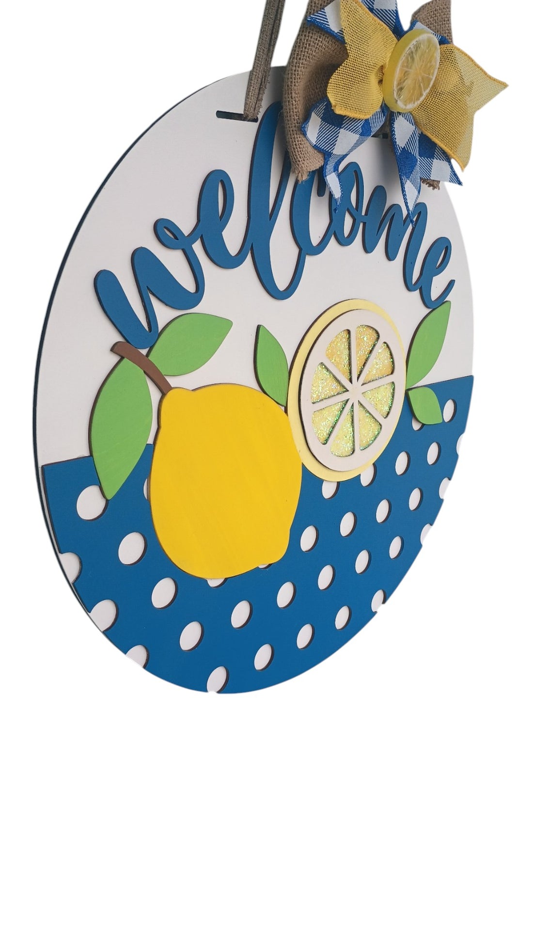 Lemon door hanger with cheerful lemon design and blue gingham bow, perfect for summer decor.

