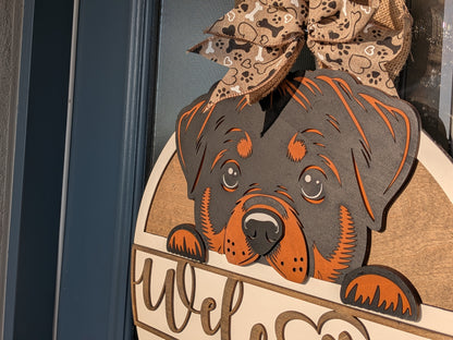 Rottweiler welcome sign displayed on a front door entryway