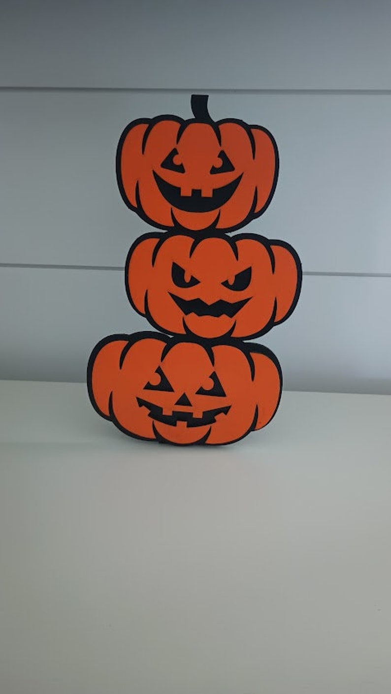 Halloween shelf sitter featuring spooky pumpkin stack