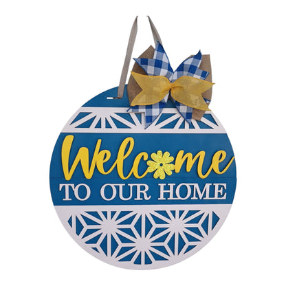  Round blue welcome sign with yellow script, white geometric pattern, and glitter flower accent