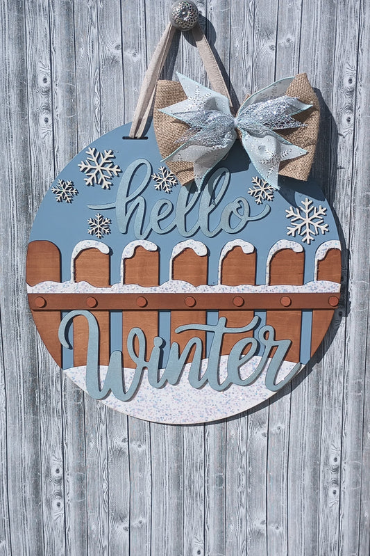 Winter door hanger with glittery Hello Winter text, hand-painted snow accents, and protective bumpers, ideal for winter front door decorations.
