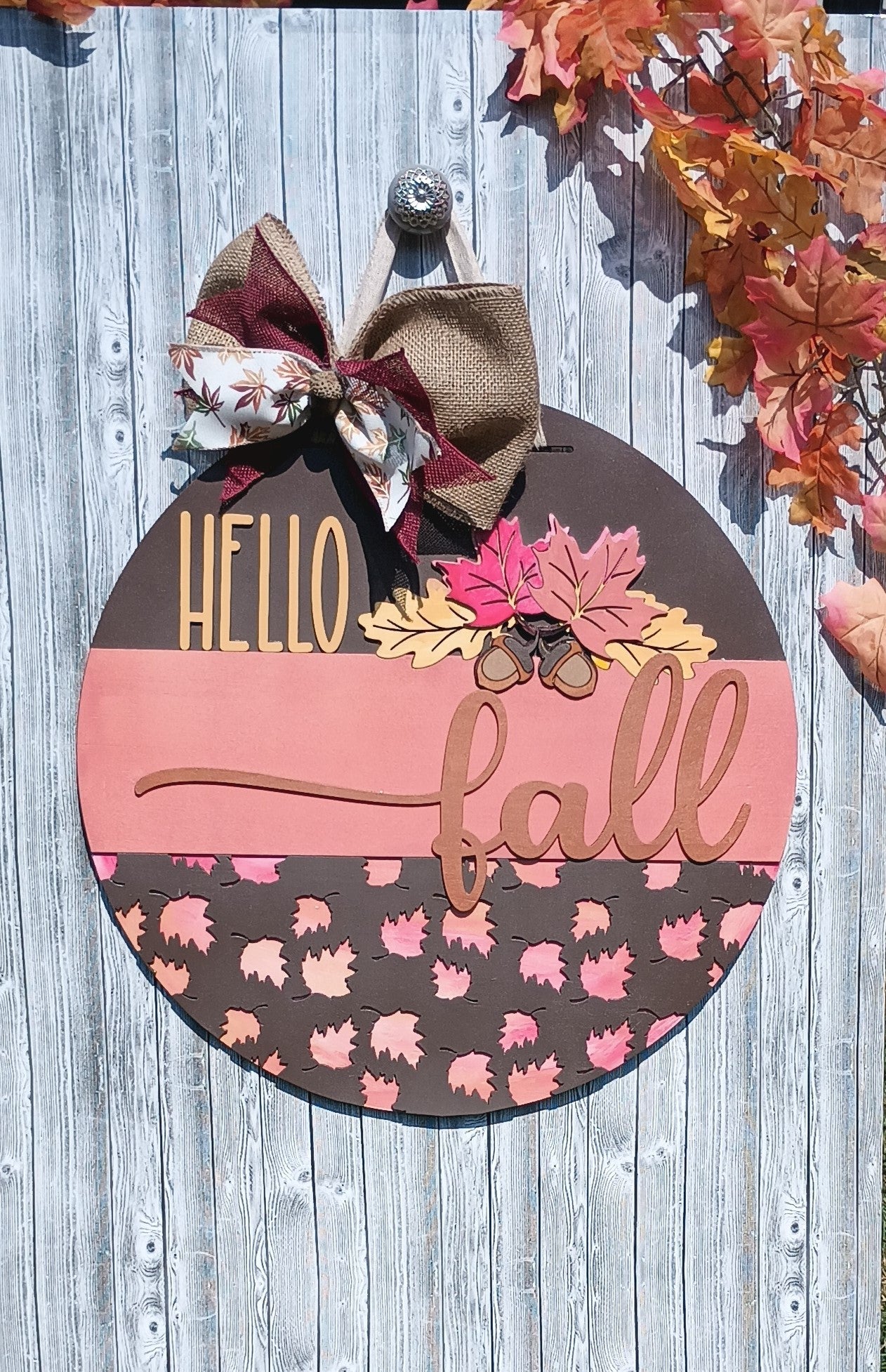 Wooden Hello Fall door hanger with burlap and ribbon bow, perfect for front porch autumn decor