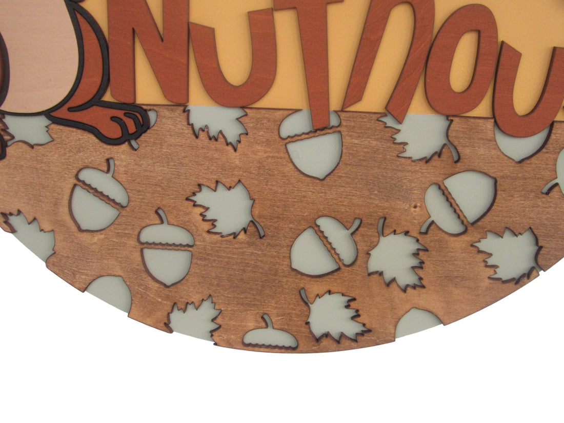 Handcrafted wooden nuthouse door hanger with cartoon design, ideal for families with a playful sense of humor.
